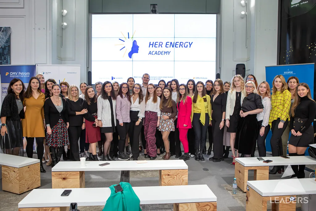 Her Energy Academy graduates and programme team celebrating together on stage