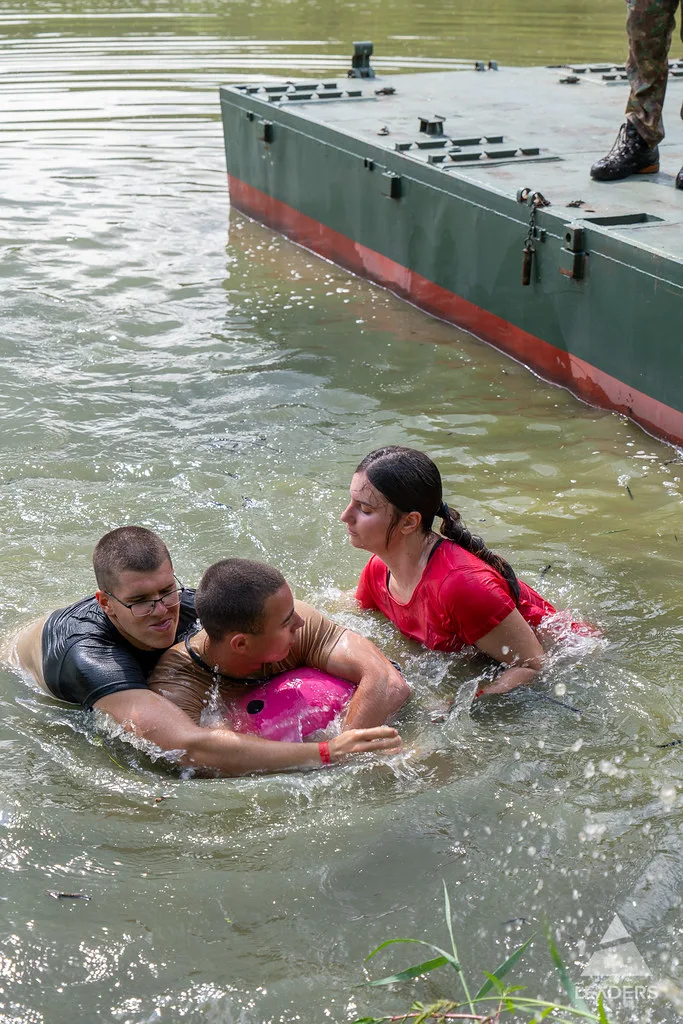 Leadership School participants supporting one another during a team challenge in the water